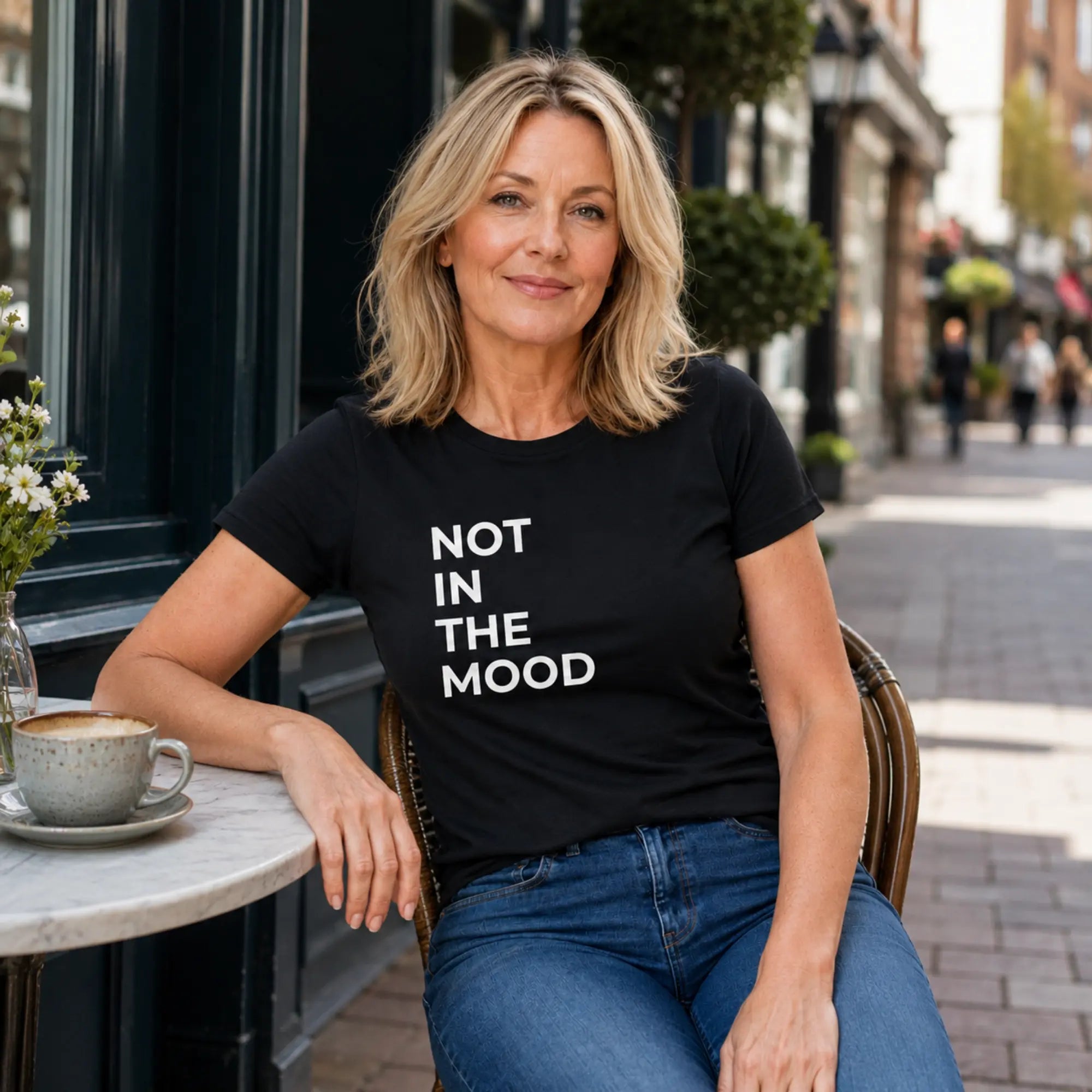 Woman wearing Not In The Mood black t-shirt on a British high street