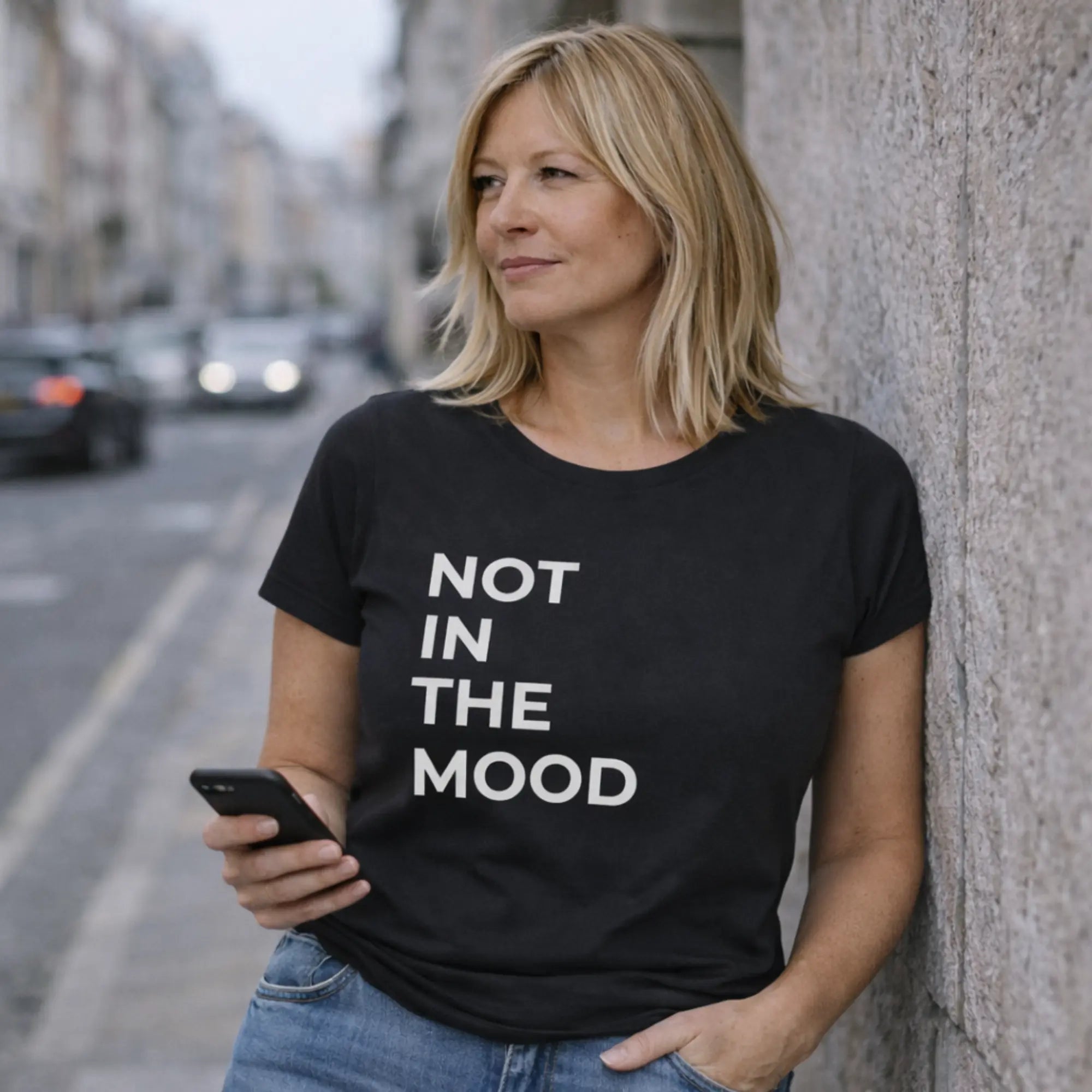 Not in the mood t shirt UK black women’s slogan tee worn on UK city street